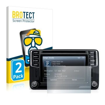 Face avant d’un emballage produit avec le logo de la marque BROTECT. À côté, l’appareil Volkswagen Amarok Discover Media 6.5
