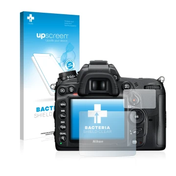 Face avant d’un emballage produit avec le logo de la marque upscreen. À côté, l’appareil Nikon D7000 est représenté avec la pr