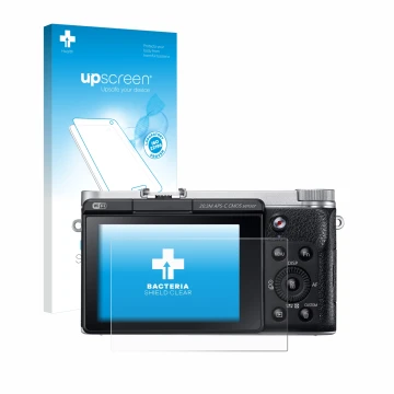 Face avant d’un emballage produit avec le logo de la marque upscreen. À côté, l’appareil Samsung NX300M est représenté avec la