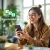 Jeune femme riant avec un smartphone à la main ; à côté, "Installation facile" avec le symbole "1 2 3" et une feuille.
